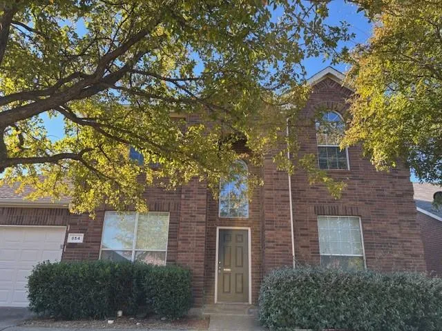 front view of a house with a tree