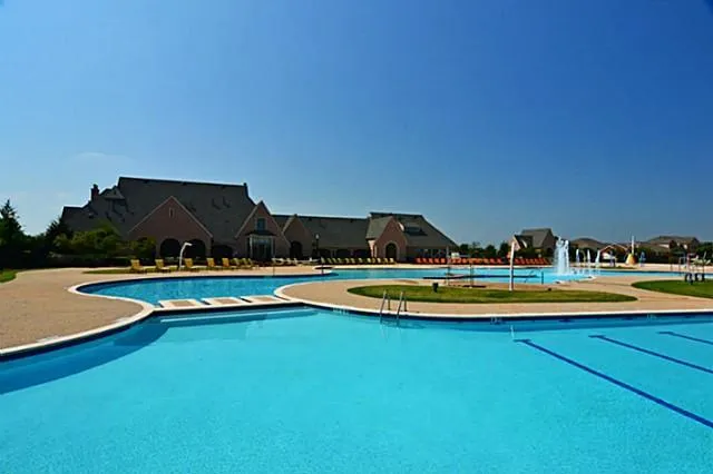a view of a swimming pool and lounge chairs