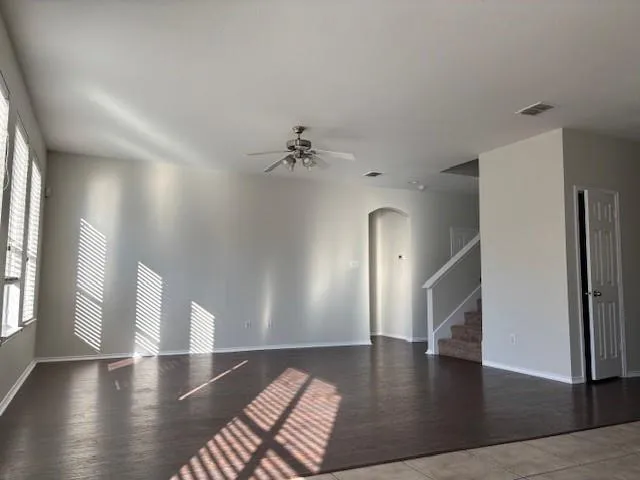 a view of a room with wooden floor and staircase