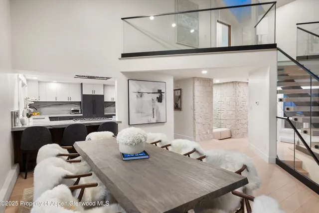 a living room with furniture and kitchen view