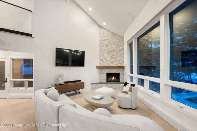 a living room with fireplace furniture and a flat screen tv
