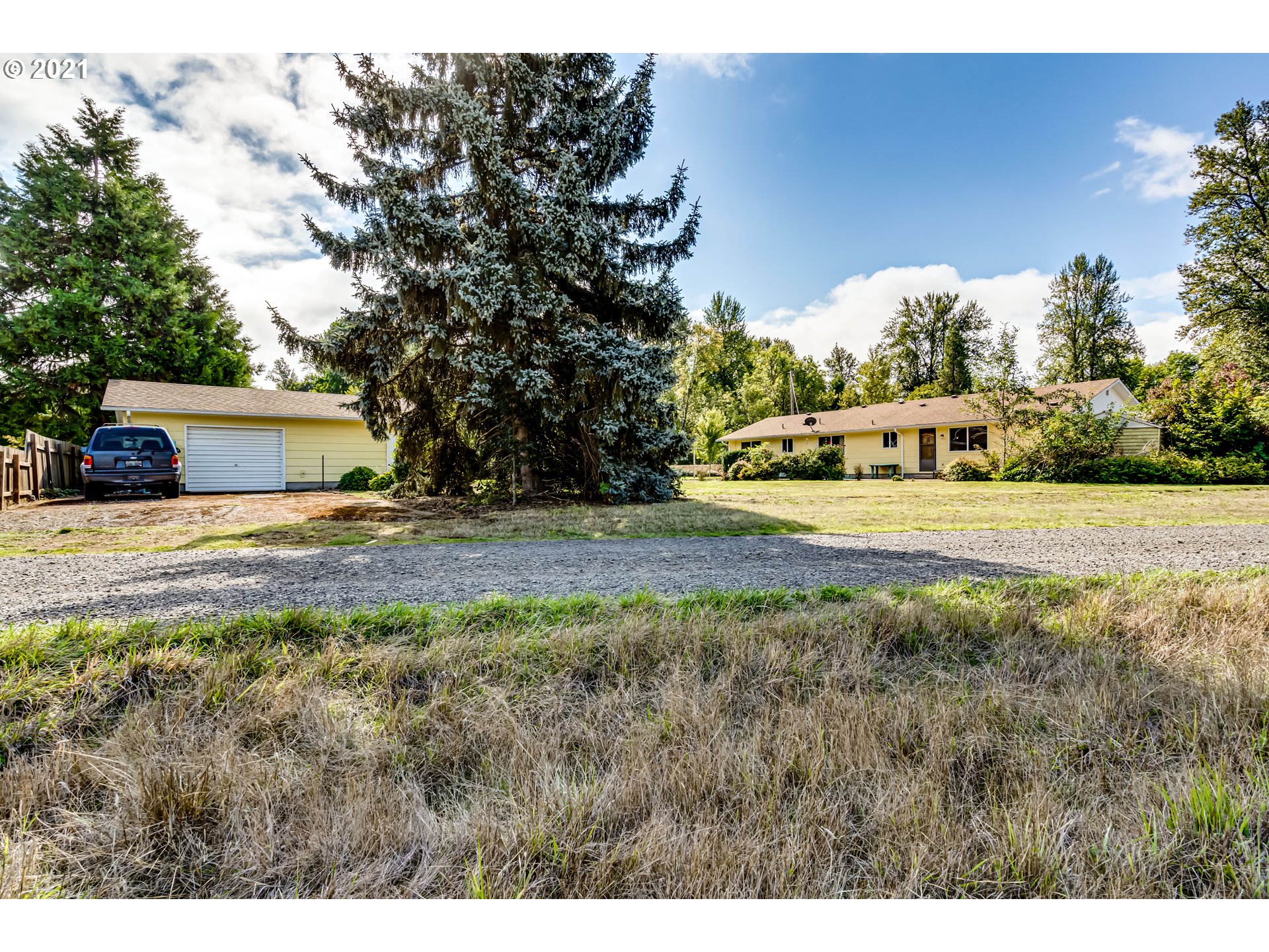 37771 Camp Creek Road Springfield, OR 97478 - Photo 25 of 30 a view of a house with yard and trees in the background