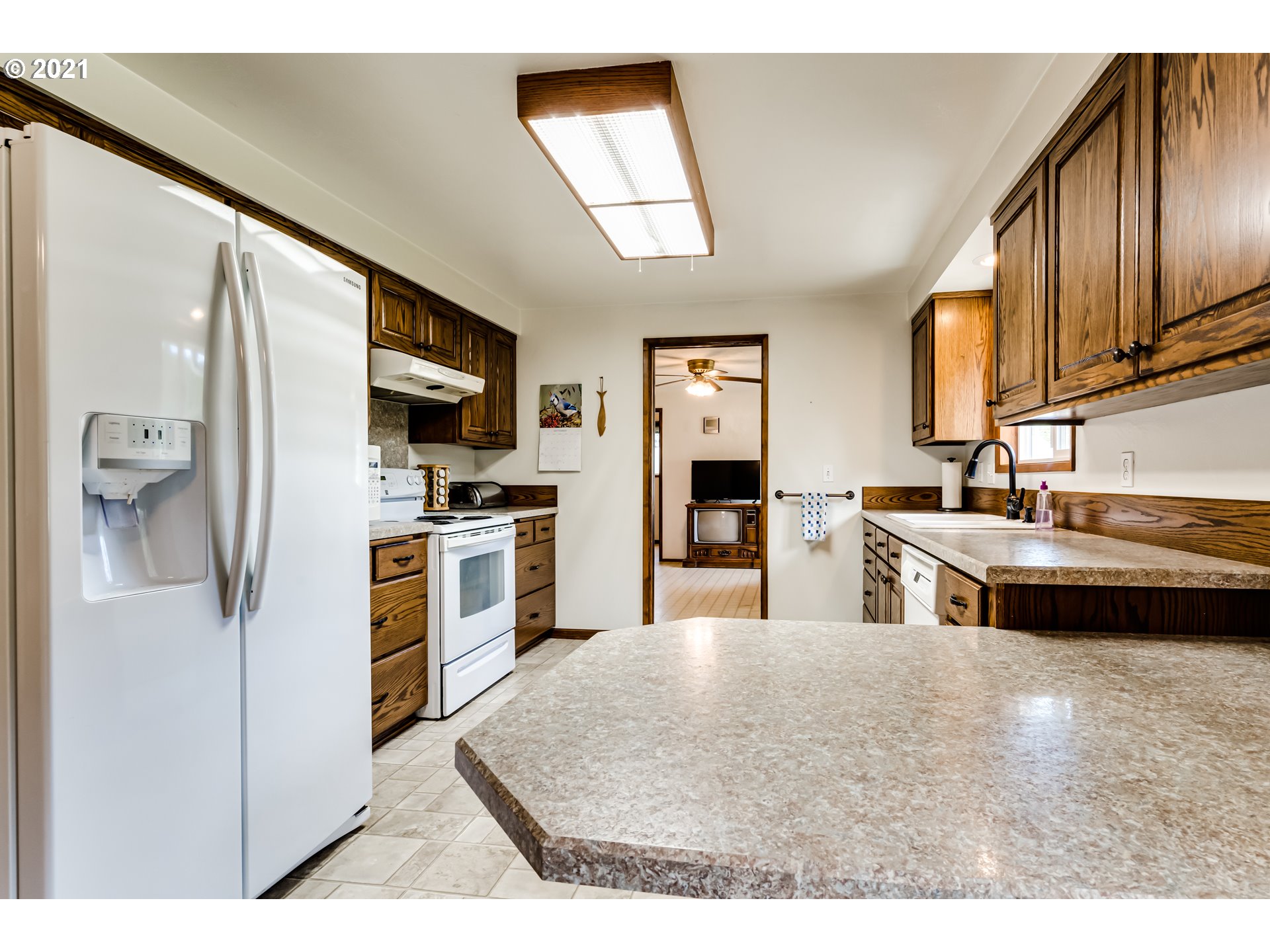 37771 Camp Creek Road Springfield, OR 97478 - Photo 8 of 30 a kitchen with stainless steel appliances kitchen island granite countertop a refrigerator and a sink