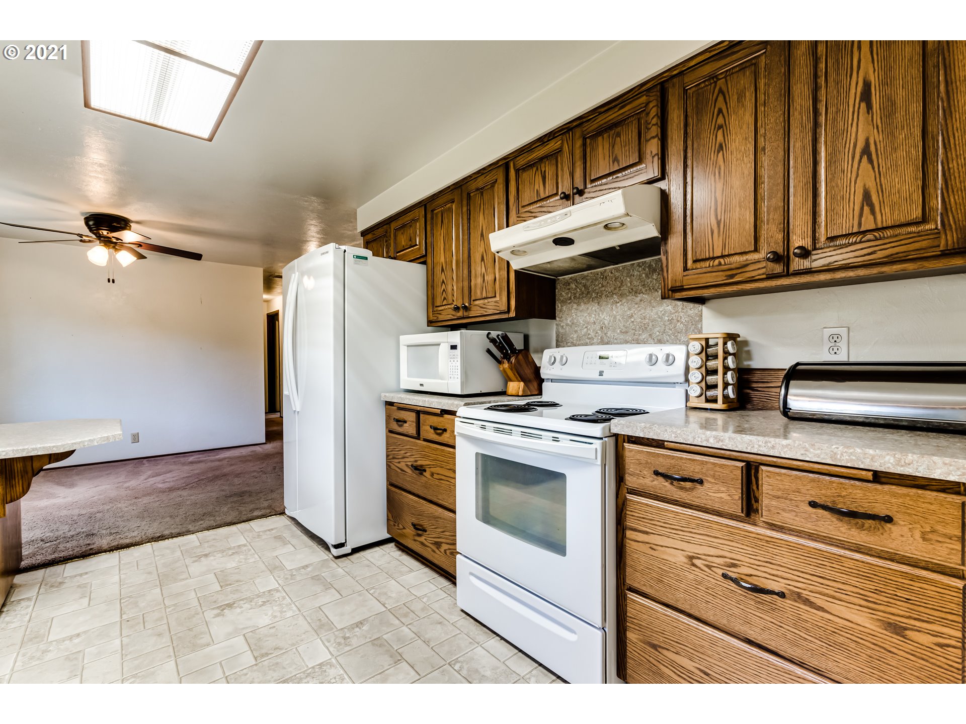 37771 Camp Creek Road Springfield, OR 97478 - Photo 10 of 30 a kitchen with stainless steel appliances granite countertop a stove a sink and a refrigerator