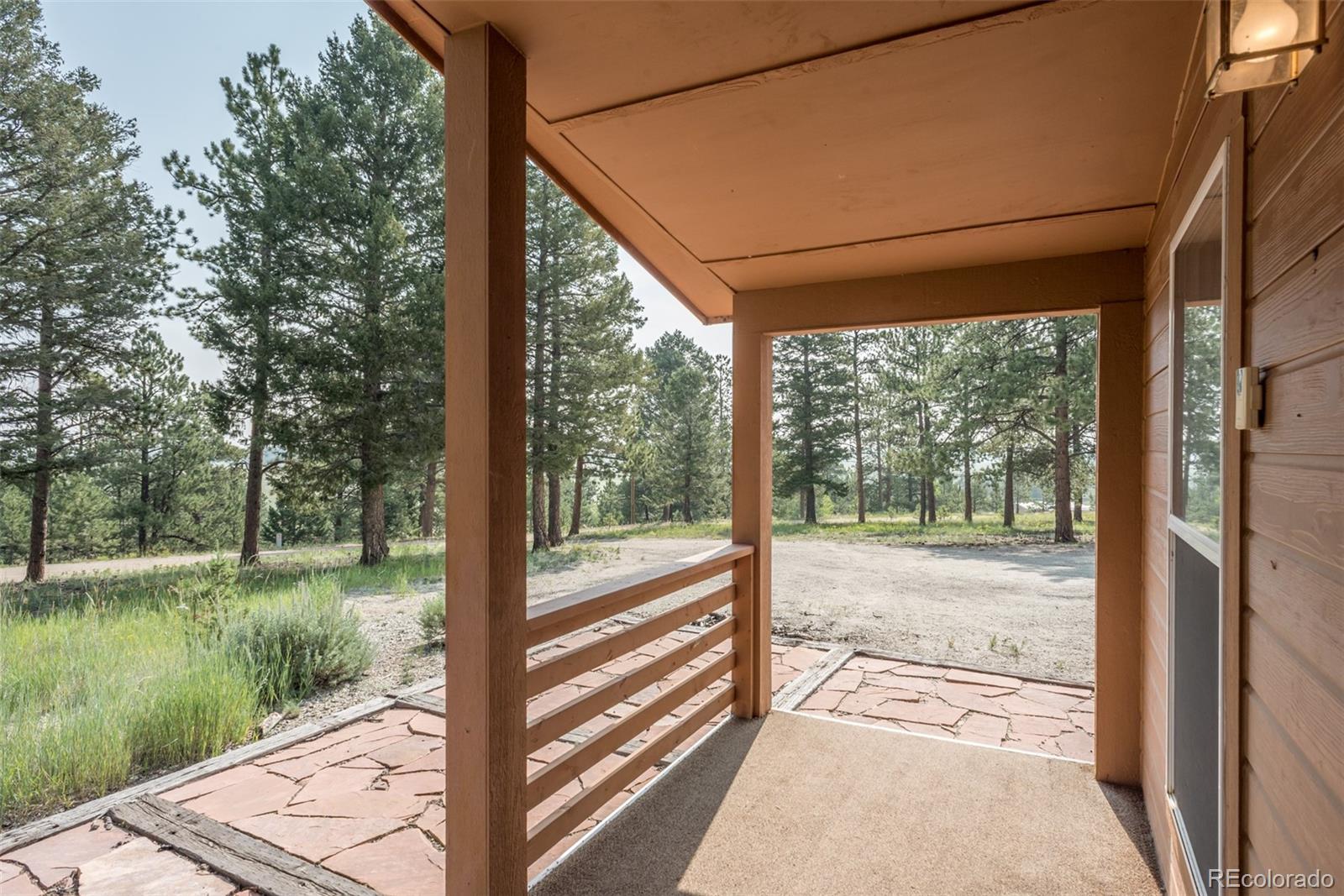 4403 Campfire Road Hartsel, CO 80449 - Photo 3 of 40 a view of a porch with wooden floor and outdoor space