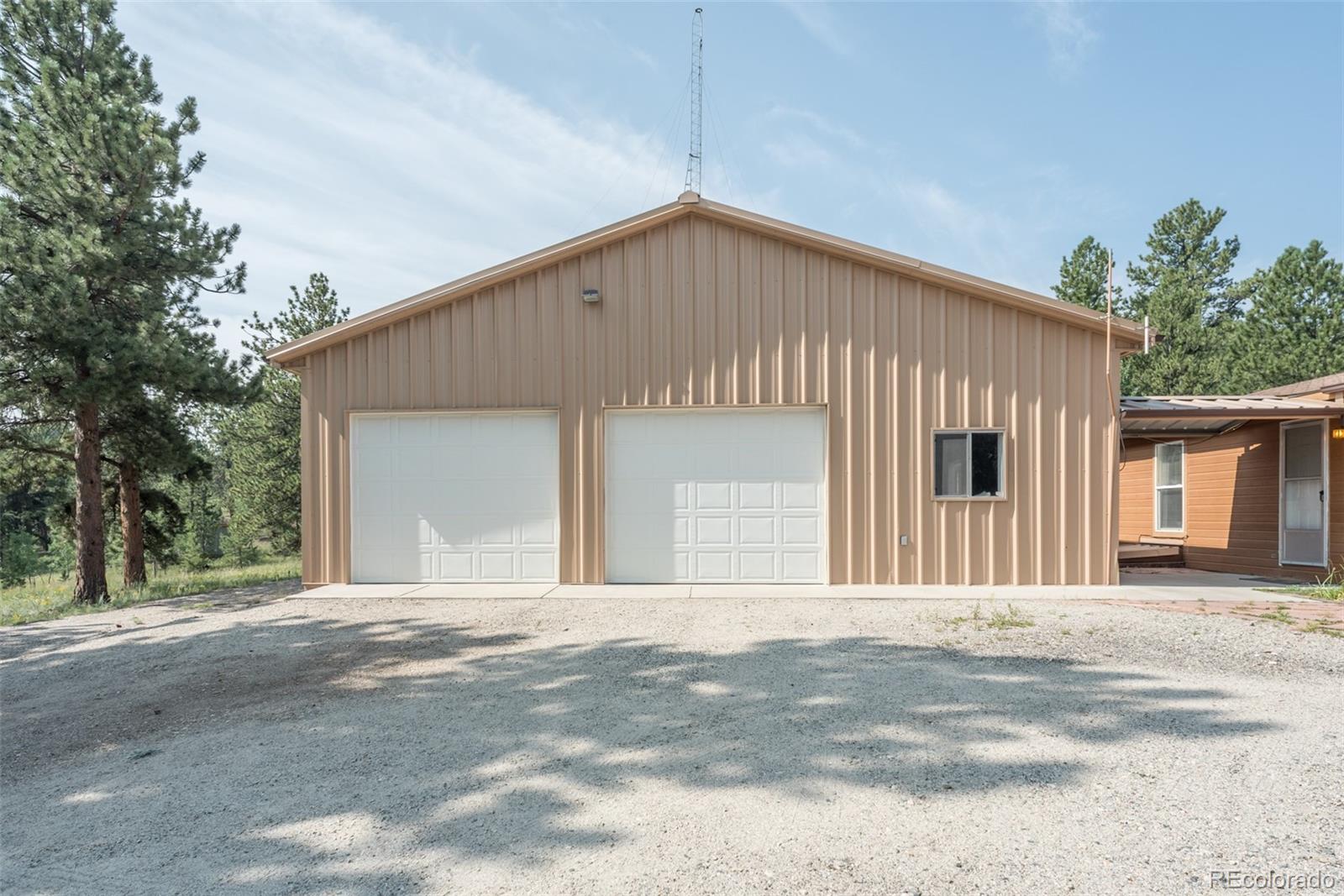 4403 Campfire Road Hartsel, CO 80449 - Photo 8 of 40 a front view of a house with a garage