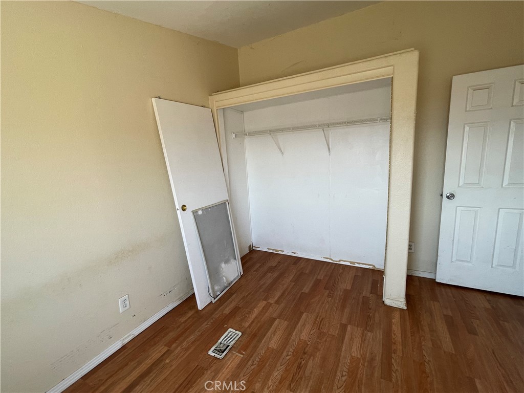 18600 Chippewa Road Lake Elsinore, CA 92532 - Photo 11 of 18 an empty room with wooden floor and entrance