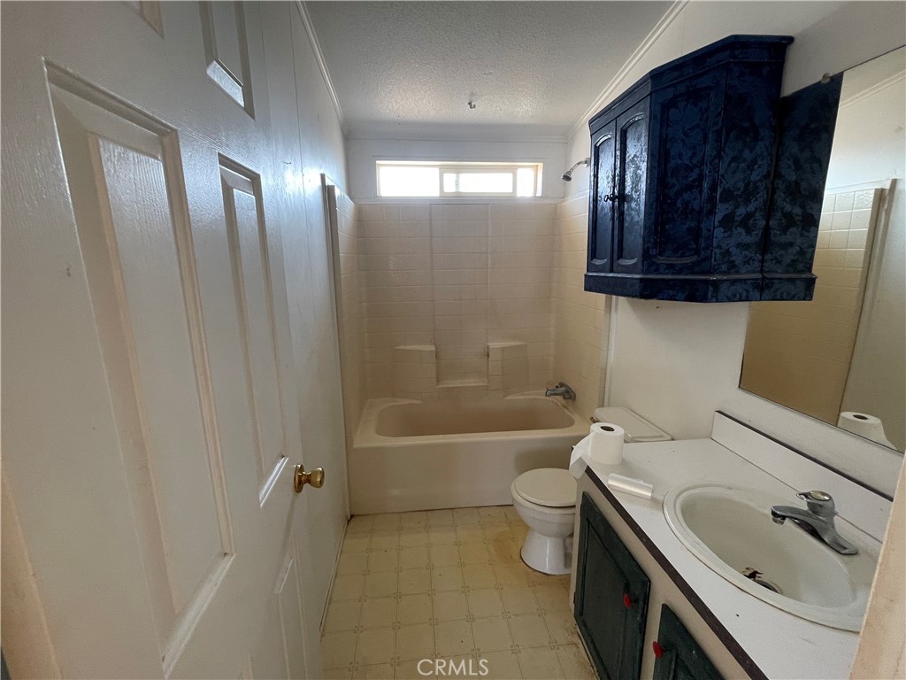18600 Chippewa Road Lake Elsinore, CA 92532 - Photo 16 of 18 a bathroom with a sink a toilet and bathtub
