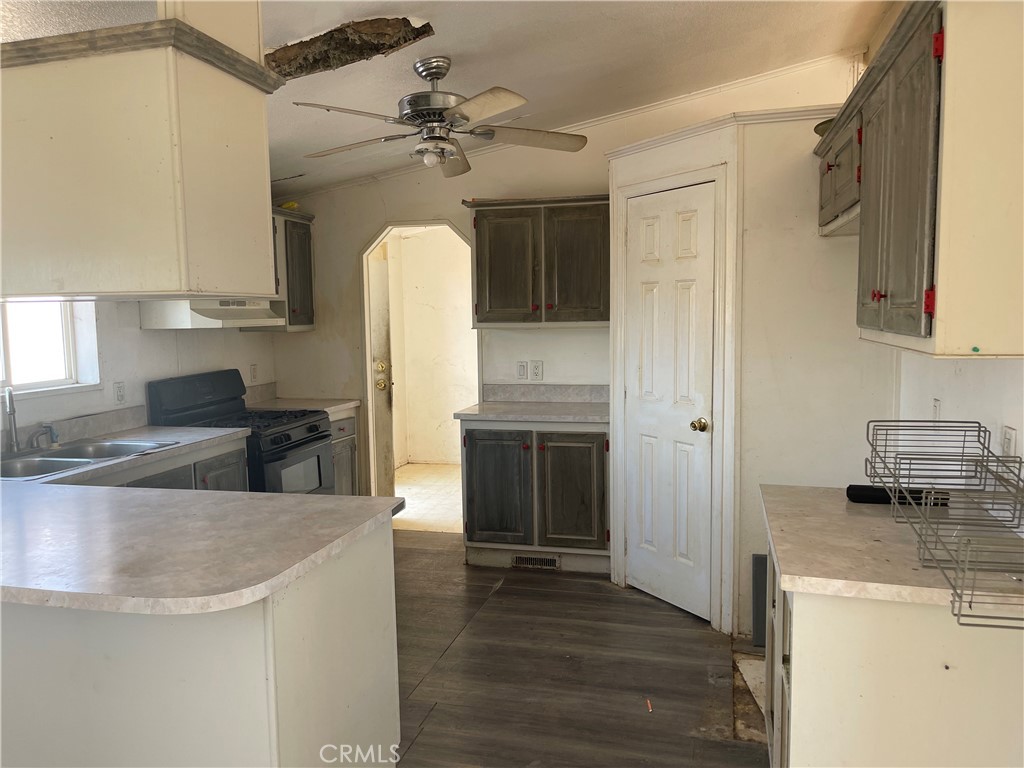 18600 Chippewa Road Lake Elsinore, CA 92532 - Photo 4 of 18 a kitchen with kitchen island a counter top space appliances and cabinets