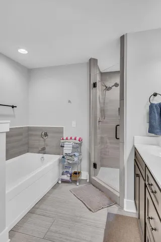 a spacious bathroom with a tub sink and shower