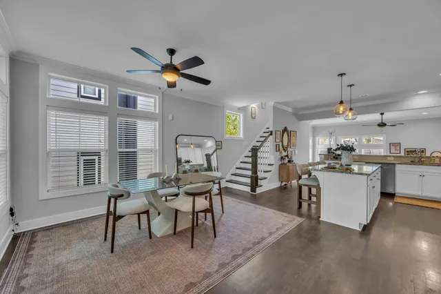 a living room with furniture a dining table and a window