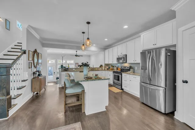 a kitchen with white cabinets and stainless steel appliances