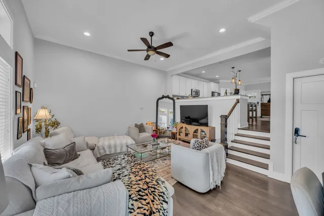 a living room with furniture and a chandelier