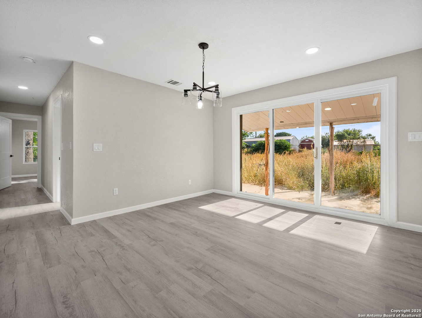 19551 Farm To Market Road 463 Devine, TX 78016 - Photo 11 of 27 a view of an empty room with a window