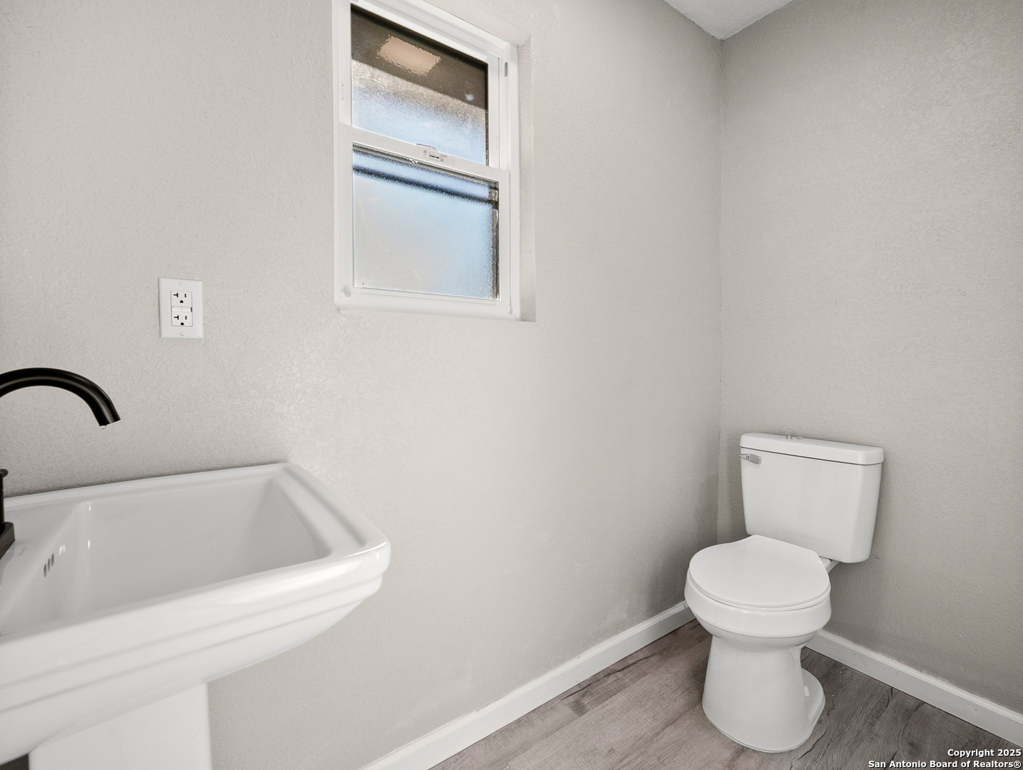 19551 Farm To Market Road 463 Devine, TX 78016 - Photo 17 of 27 a bathroom with a toilet sink and mirror