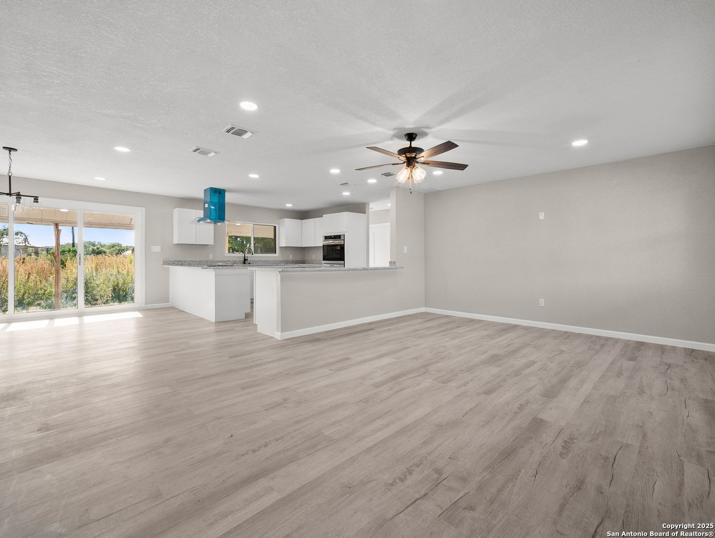 19551 Farm To Market Road 463 Devine, TX 78016 - Photo 2 of 27 a view of a kitchen with a sink and a stove top oven