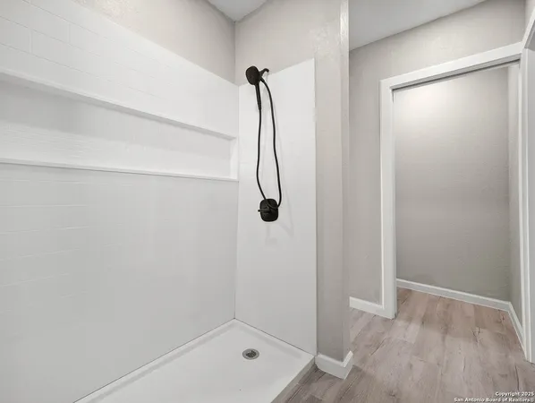 a bathroom with a glass shower door