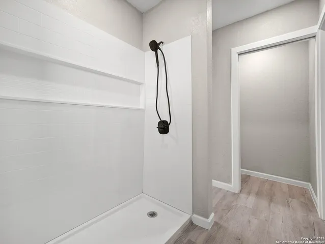 a bathroom with a glass shower door