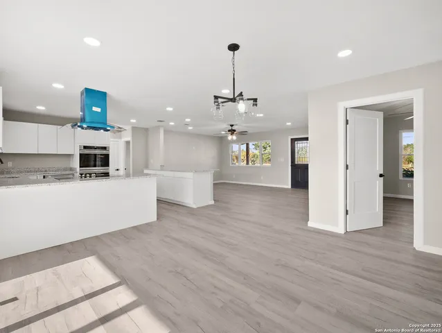 a view of a kitchen with a sink stainless steel appliances and cabinets
