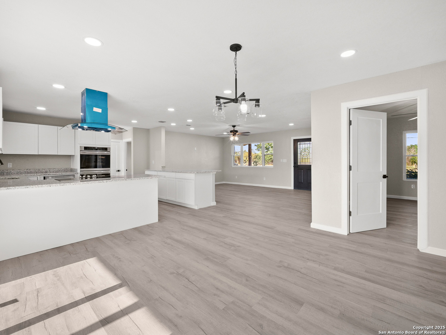 19551 Farm To Market Road 463 Devine, TX 78016 - Photo 8 of 27 a view of a kitchen with a sink stainless steel appliances and cabinets