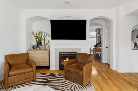 a living room with furniture fireplace and flat screen tv