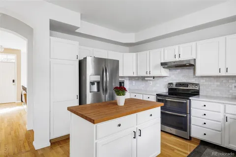 a kitchen with a stove a refrigerator and a sink