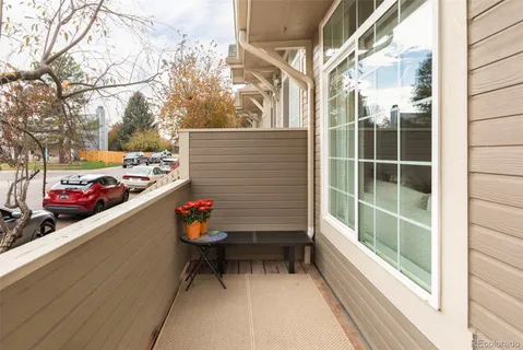 a roof deck with couch and potted plant