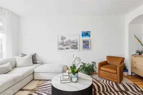 a living room with furniture and a potted plant