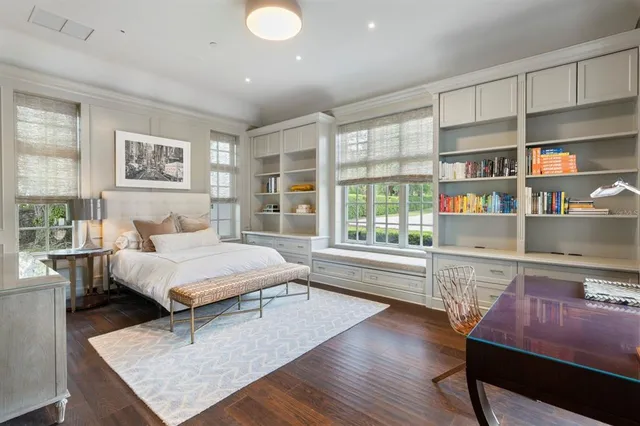 a bedroom with a bed and a large window