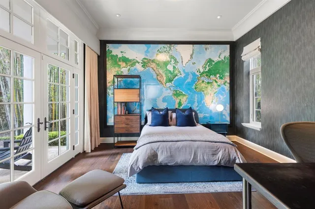 a bedroom with a bed wooden floor and lamp