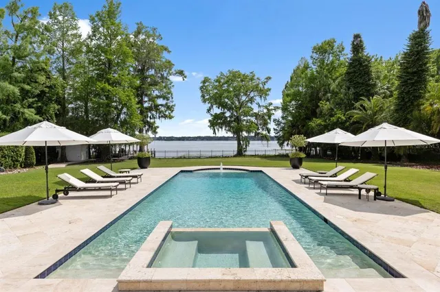 a front view of a house with lake view and a dining table with chairs
