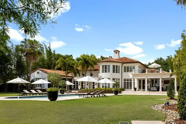 a kitchen with stainless steel appliances granite countertop a refrigerator a stove and a sink