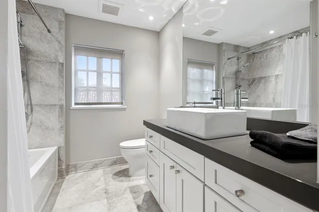 an aerial view of a house with garden space and lake view