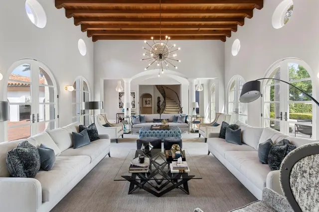 a dining room with furniture a chandelier and wooden floor