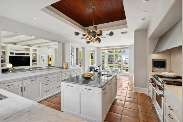 a kitchen with stainless steel appliances kitchen island granite countertop a sink and cabinets