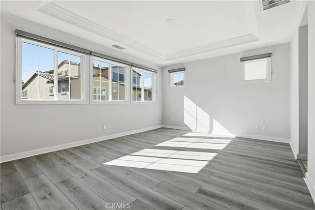 a view of a livingroom with wooden floor and stairs
