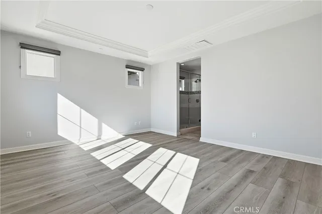 a view of an empty room and wooden floor