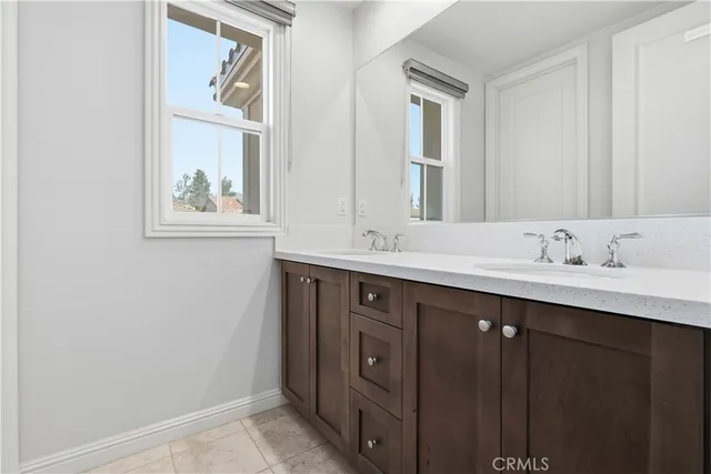 a bathroom with a double vanity sink mirror and