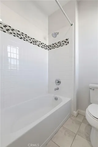 a bathroom with a bathtub a toilet and a shower