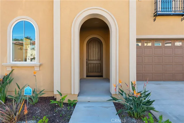 a view of a brick house with potted plants