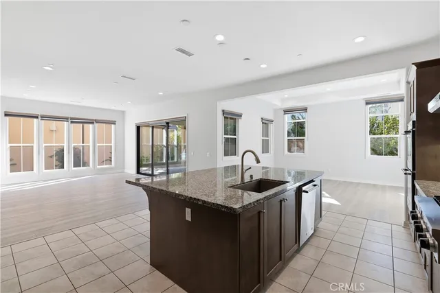 a kitchen with granite countertop a sink and a stove