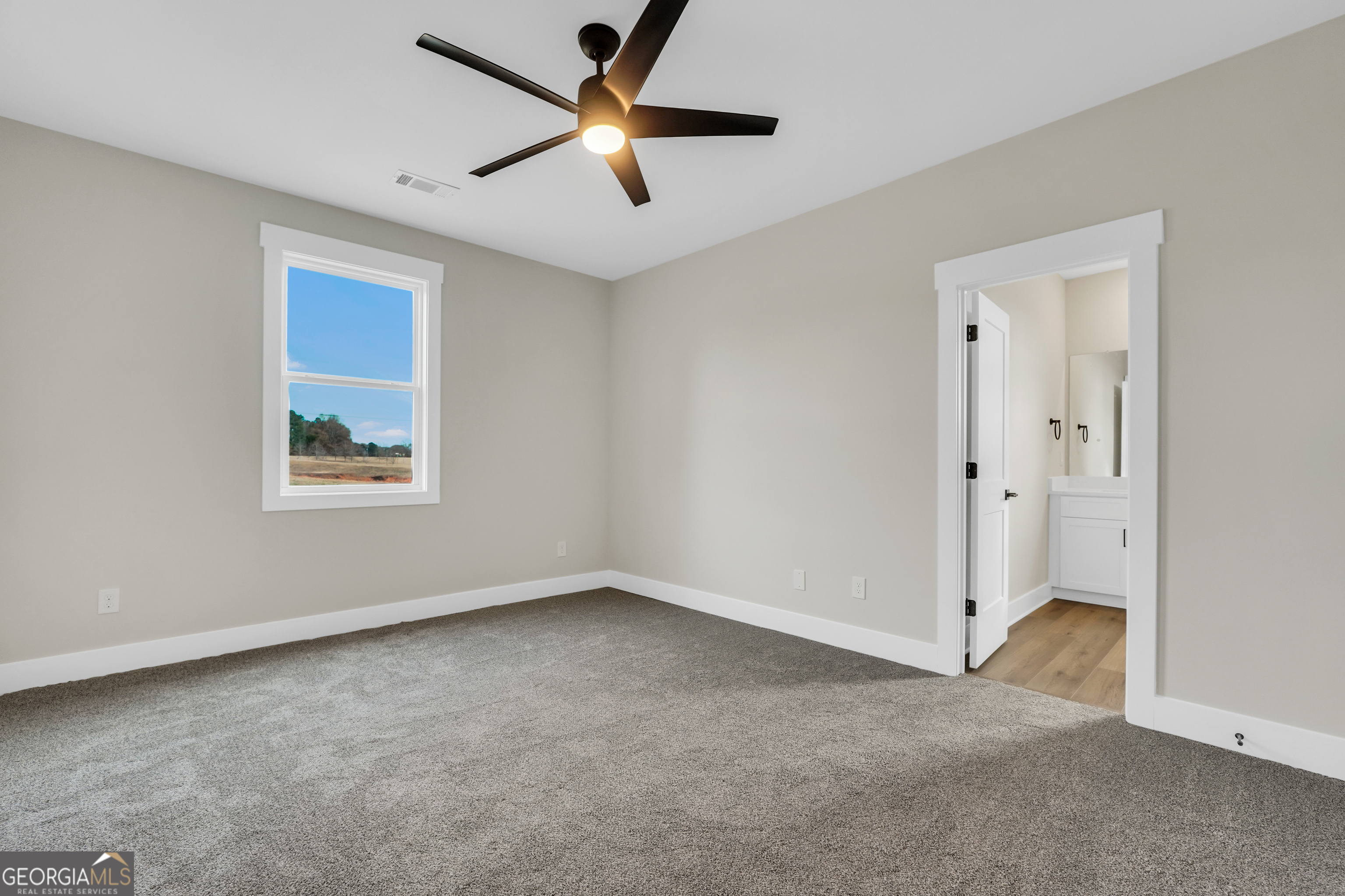 267 East Knight Road McDonough, GA 30252 - Photo 14 of 17 an empty room with fan and windows