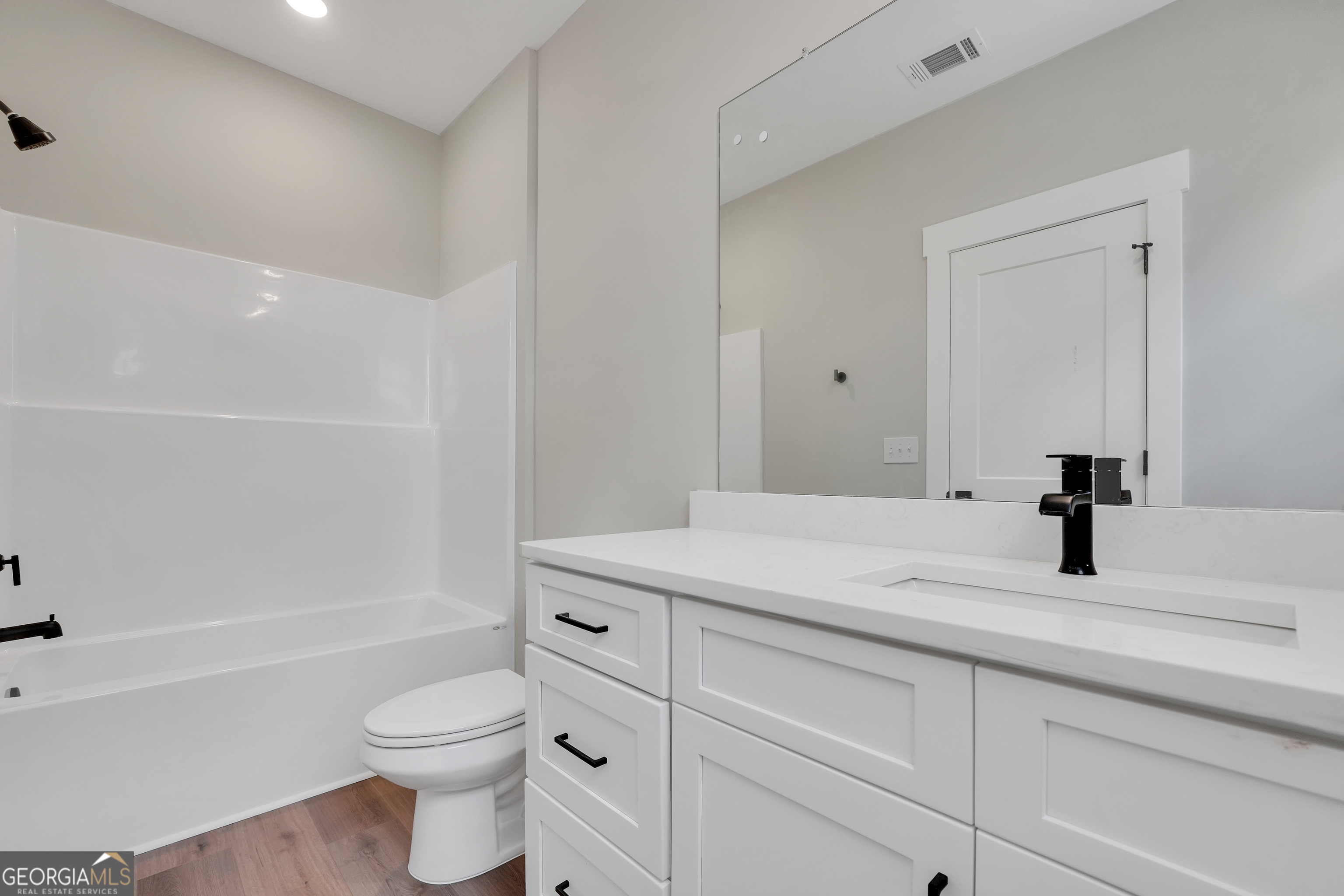 267 East Knight Road McDonough, GA 30252 - Photo 16 of 17 a bathroom with a granite countertop toilet sink and mirror