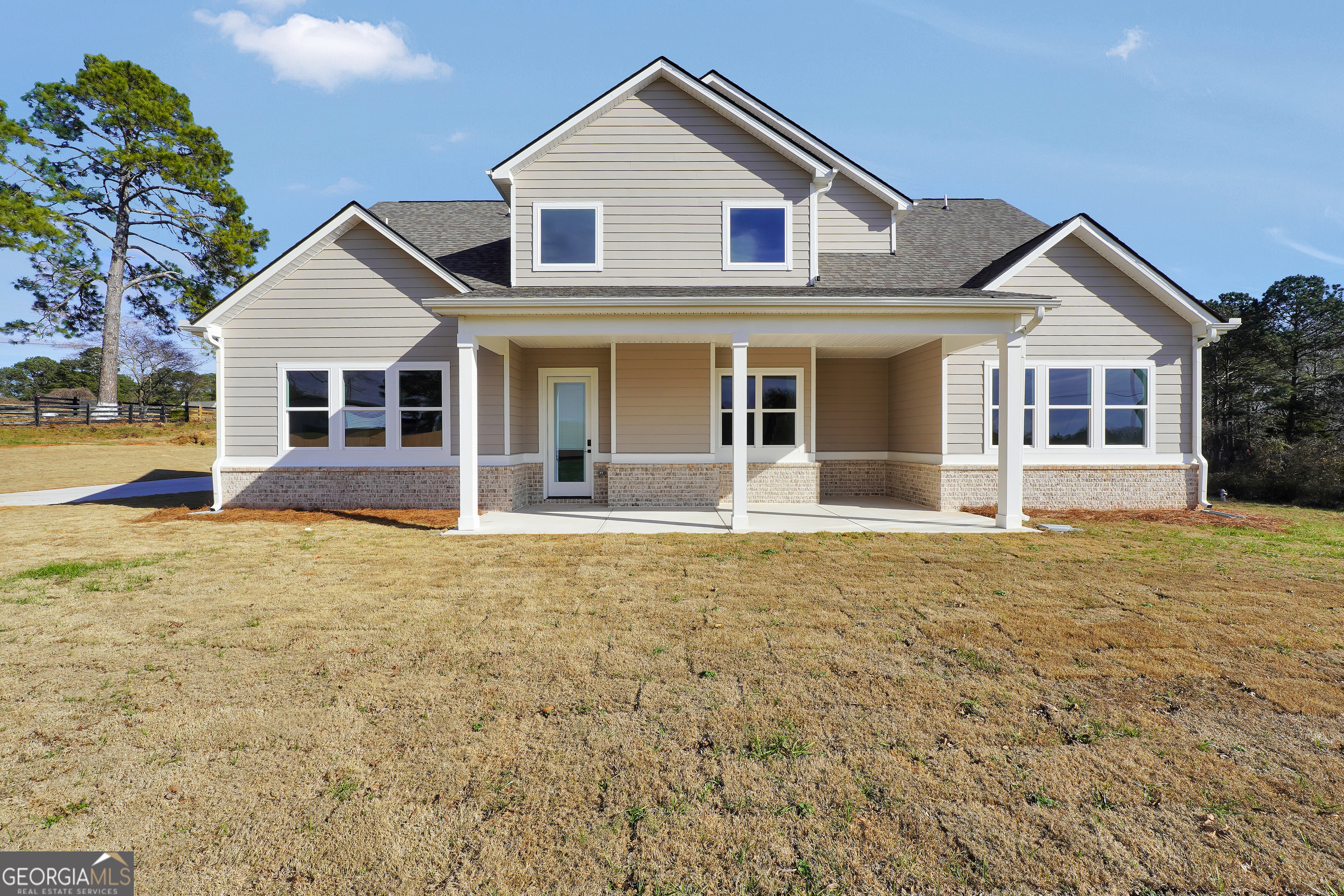 267 East Knight Road McDonough, GA 30252 - Photo 5 of 17 a view of a white house with a yard and large tree