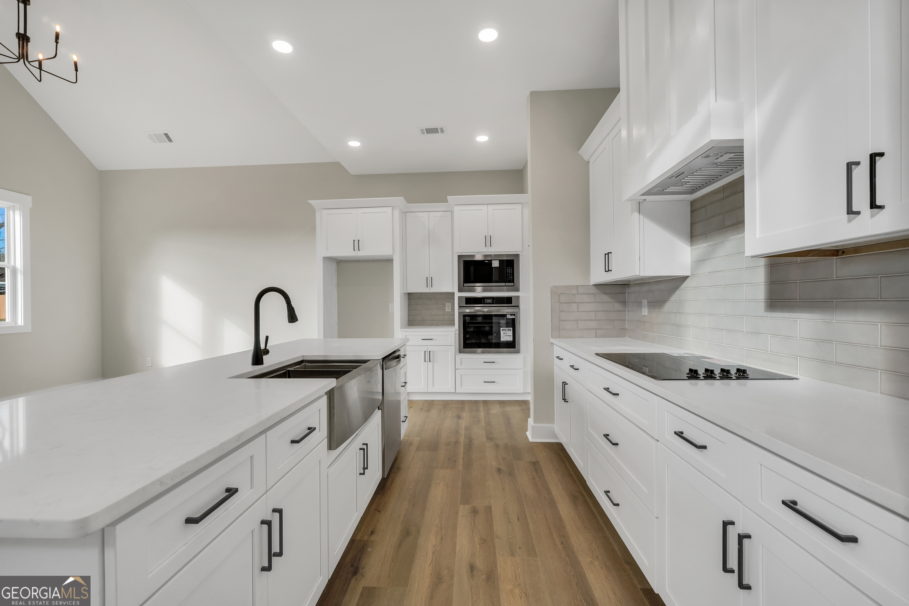 267 East Knight Road McDonough, GA 30252 - Photo 7 of 17 a large kitchen with stainless steel appliances granite countertop a lot of counter space and wooden floors