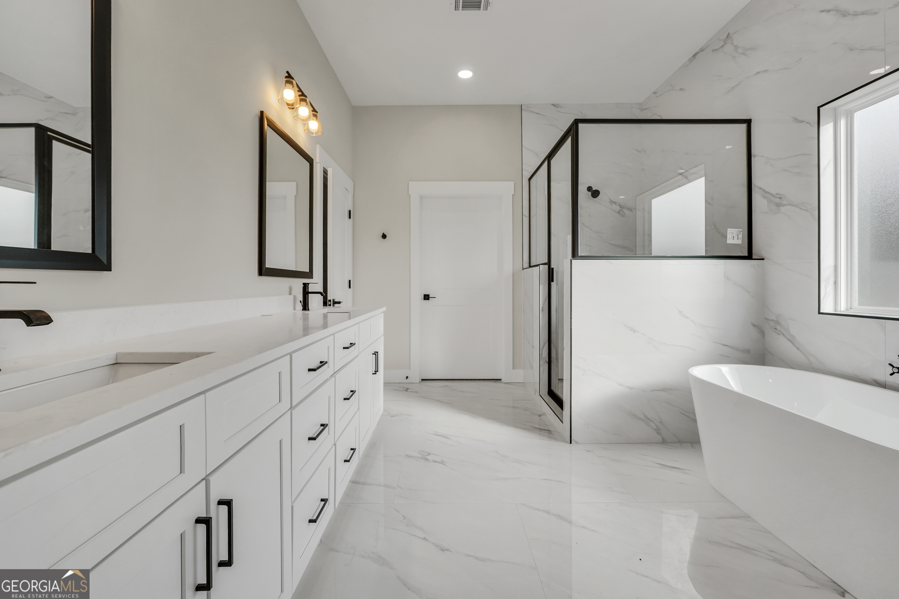 267 East Knight Road McDonough, GA 30252 - Photo 10 of 17 a spacious bathroom with a double vanity sink a mirror and a shower