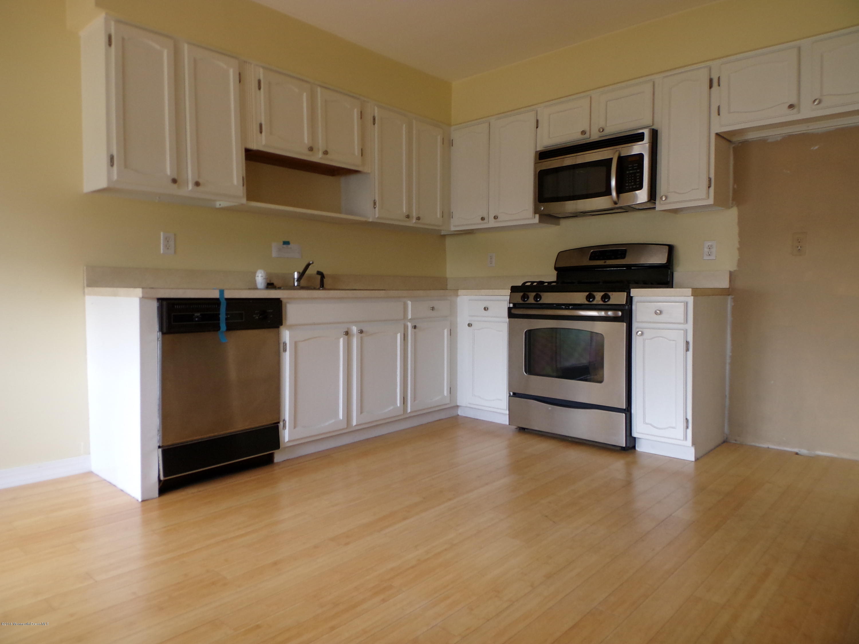 1882 Lanes Mill Road Brick, NJ 08724 - Photo 3 of 15 a kitchen with stainless steel appliances granite countertop a stove a microwave and a refrigerator
