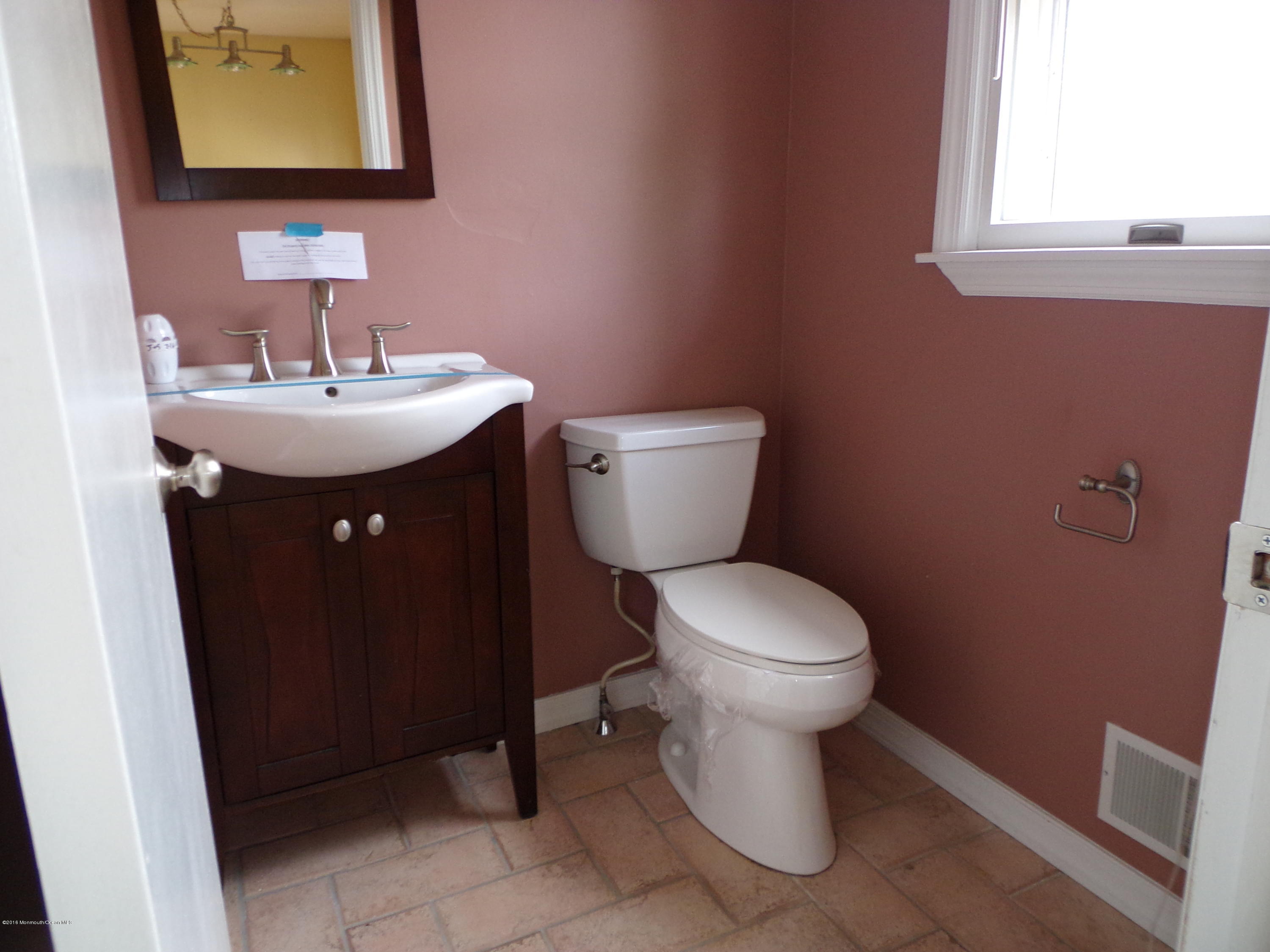 1882 Lanes Mill Road Brick, NJ 08724 - Photo 4 of 15 a bathroom with a sink toilet and mirror
