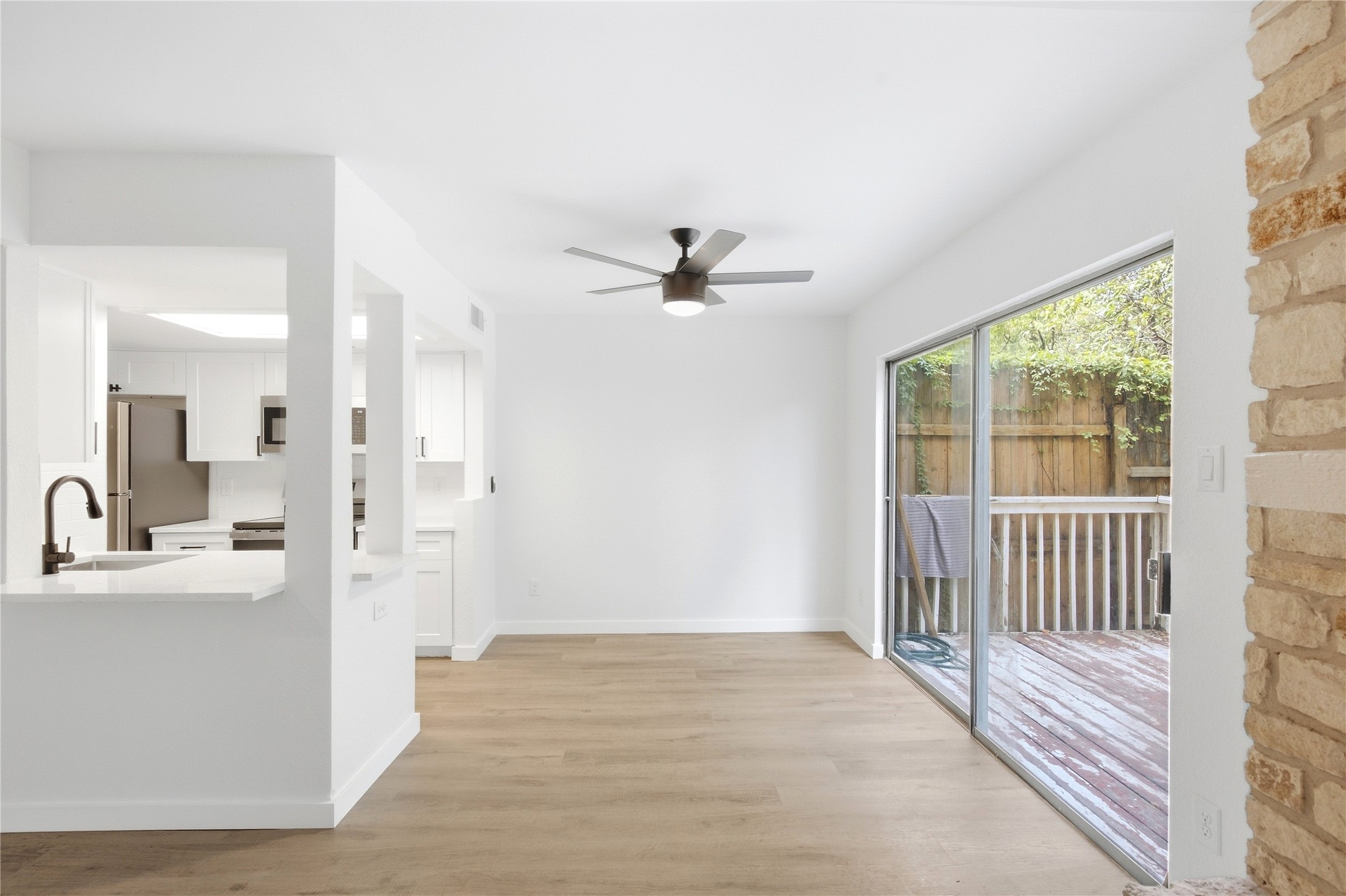 2500 Jones Road, Unit B Austin, TX 78745 - Photo 22 of 37 Sliding glass doors open directly to a private wooden deck from this open-concept dining area.
