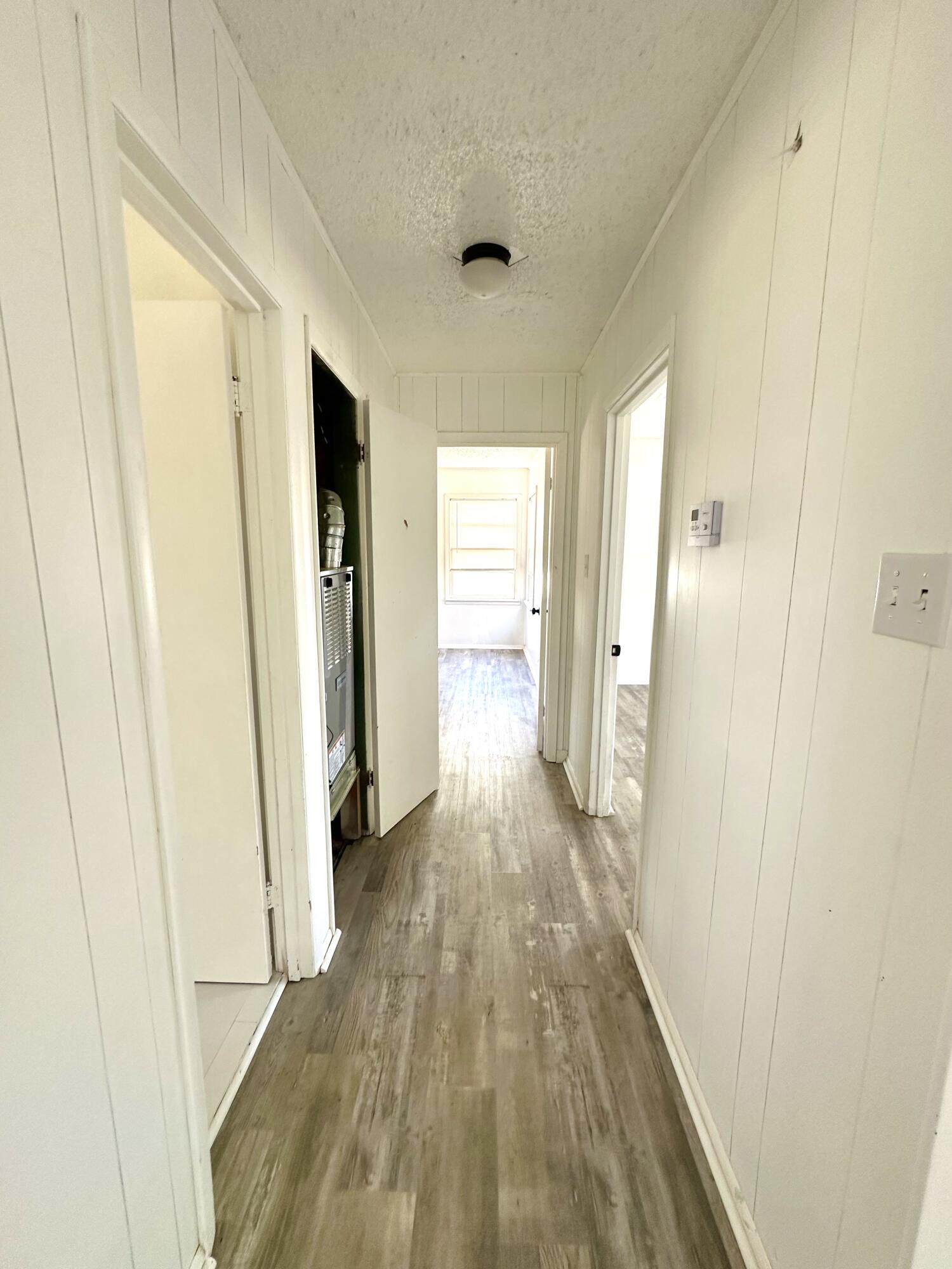 1827 8th Street Levelland, TX 79336 - Photo 15 of 25 a view of a hallway with wooden floor and closet